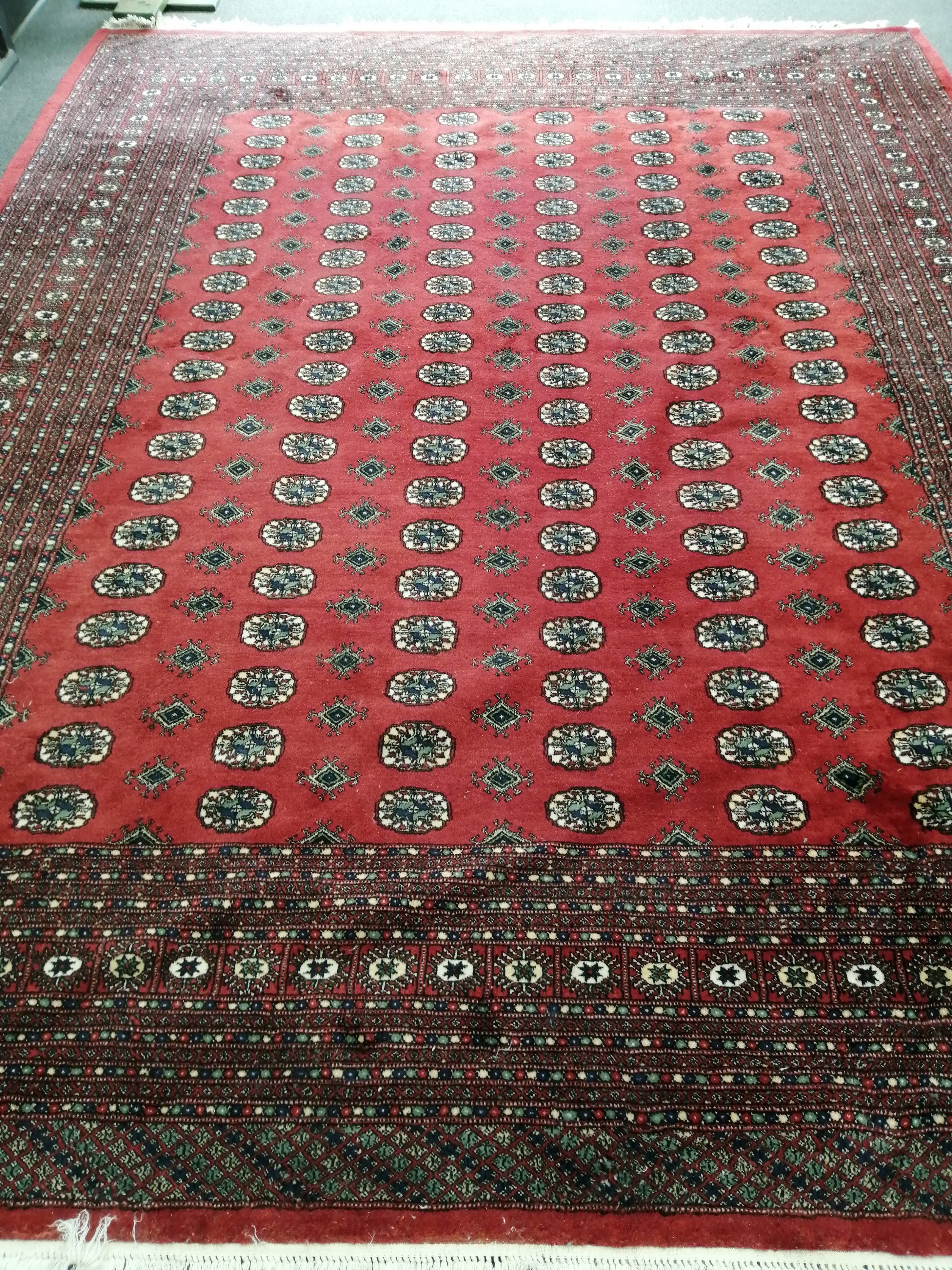 A Bokhara red ground carpet 360 x 284 cms